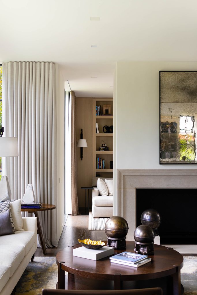 Living room with floor-to-ceiling drapery and a stone fireplace in an Atlanta home