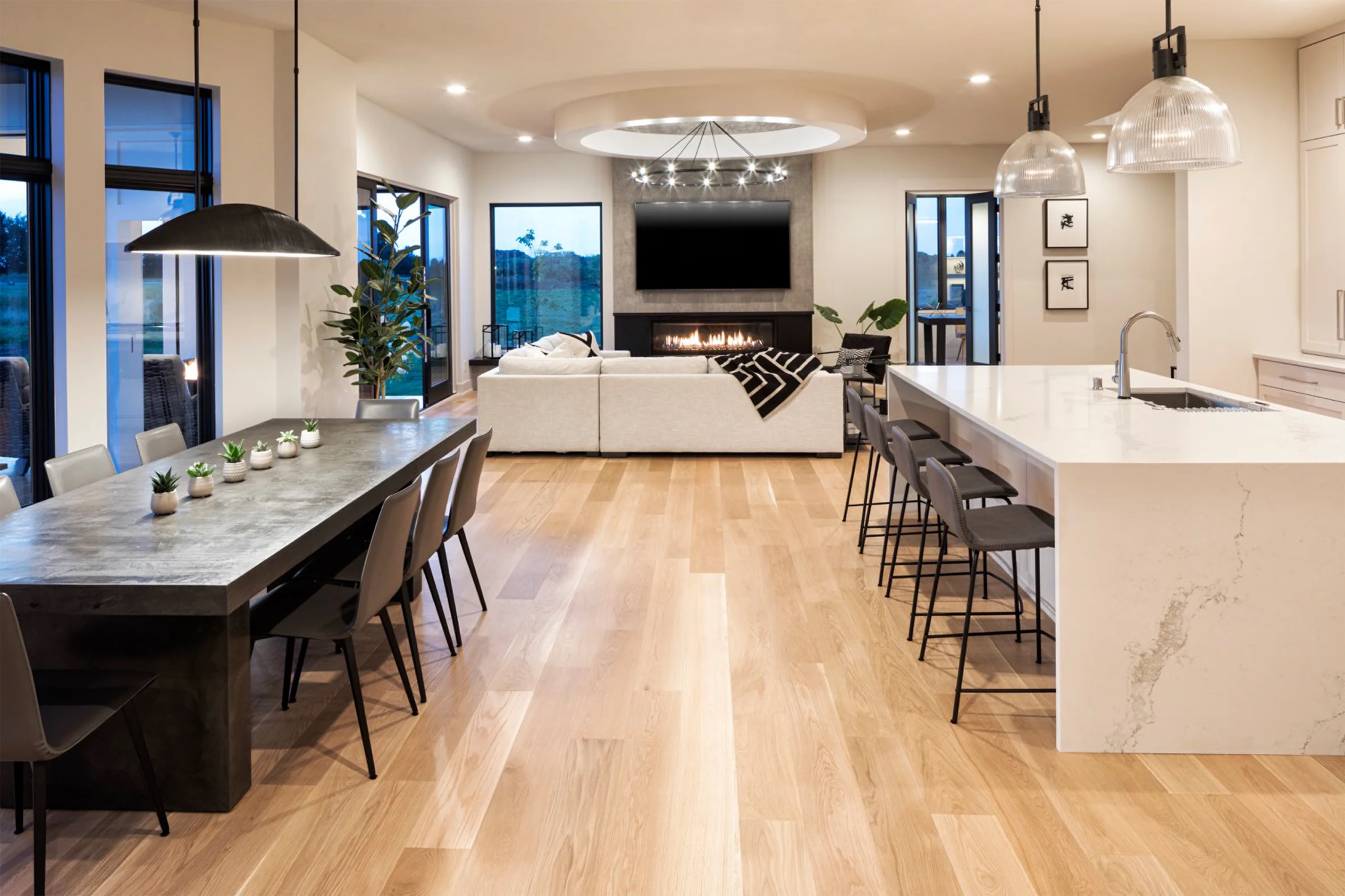 Open kitchen, dining and living area with a fireplace in a Minneapolis home