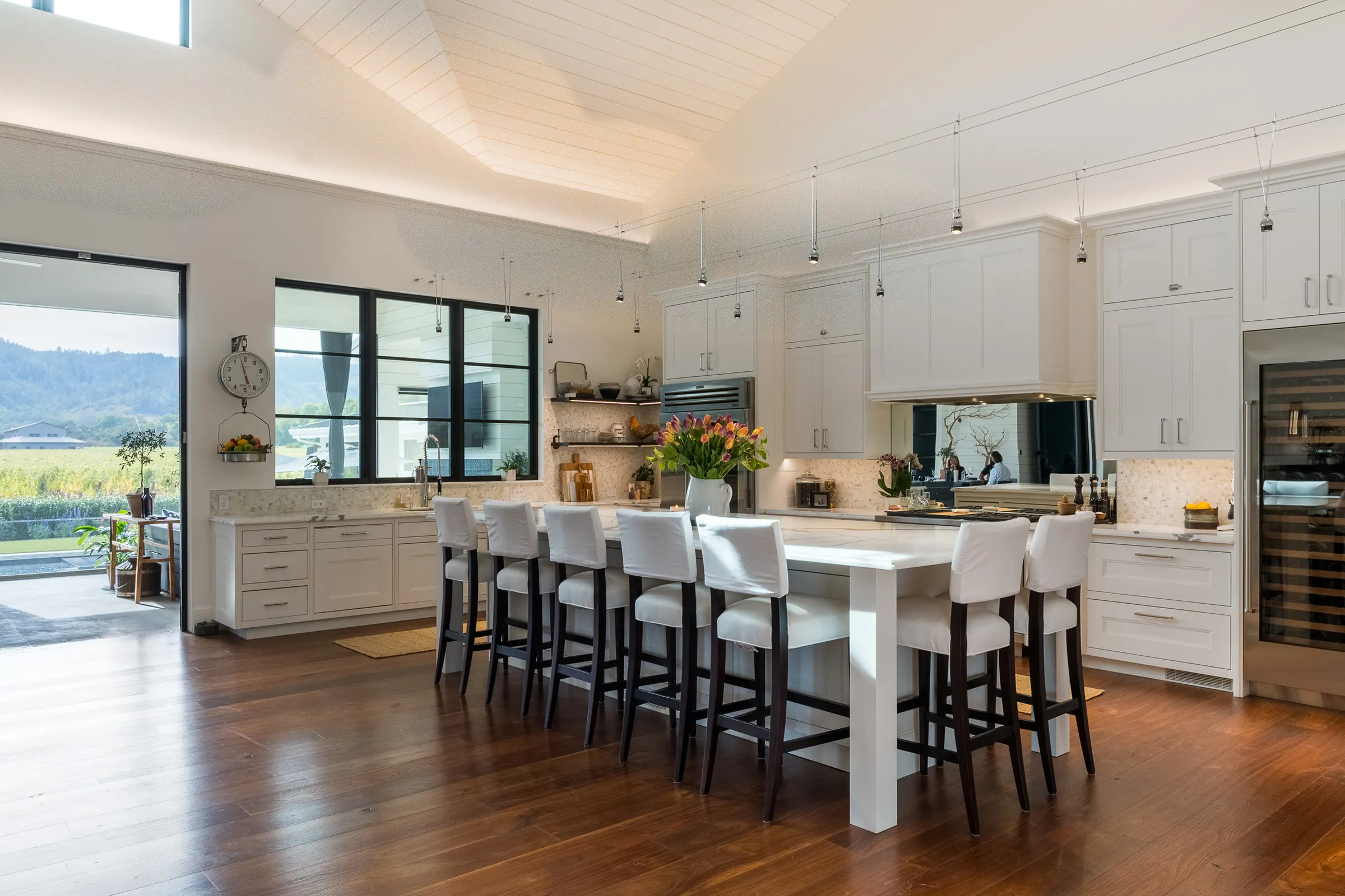 Kitchen with suspended lighting and vineyard views in a Northern California home
